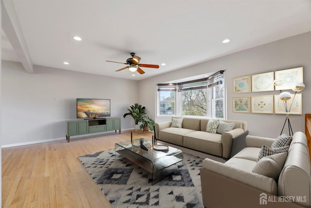 living area featuring a ceiling fan, baseboards, recessed lighting, and light wood-style floors