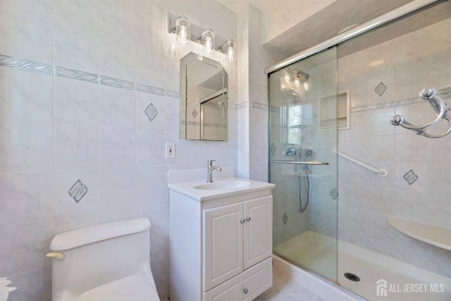 full bath with vanity, toilet, and a stall shower