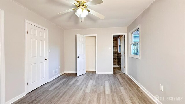 unfurnished bedroom with ceiling fan and light wood-type flooring