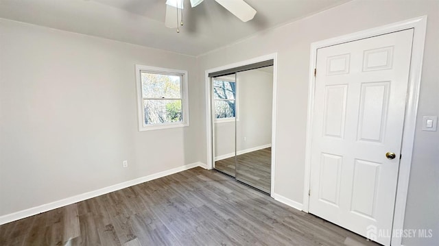 unfurnished bedroom with ceiling fan, a closet, and light hardwood / wood-style flooring