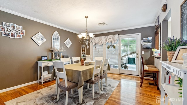 587 Malboro Rd, Old Bridge, NJ 08857 - dining space with a chandelier, crown molding, and wood finished floors