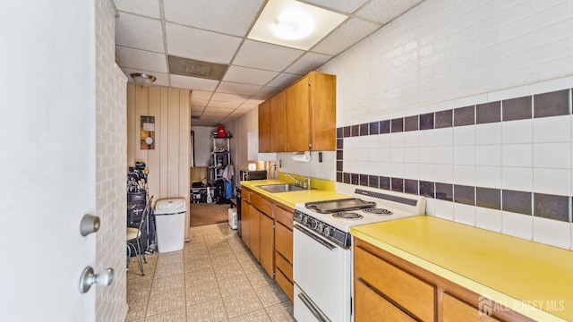 587 Malboro Rd, Old Bridge, NJ 08857 - kitchen with electric range, light floors, light countertops, a paneled ceiling, and brown cabinetry
