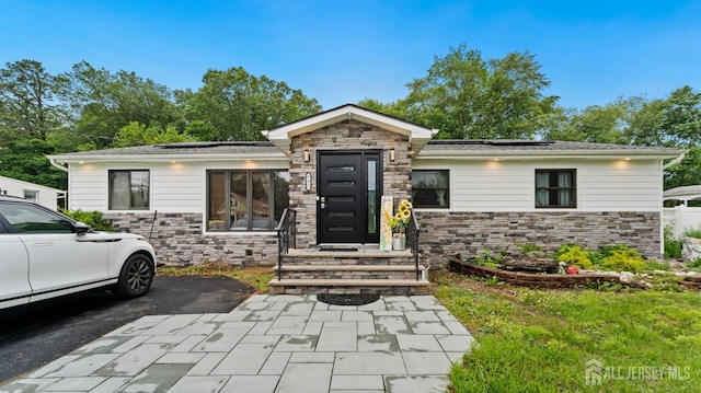 587 Malboro Rd, Old Bridge, NJ 08857 - view of front of property with stone siding and solar panels