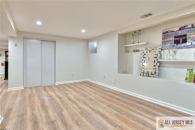 interior space with recessed lighting, wood finished floors, visible vents, baseboards, and a closet