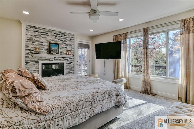 bedroom featuring carpet, a fireplace, baseboards, and multiple windows