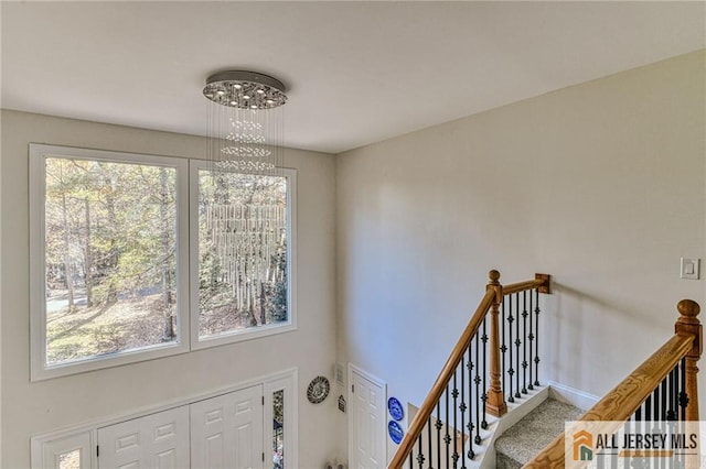 staircase with baseboards and carpet flooring