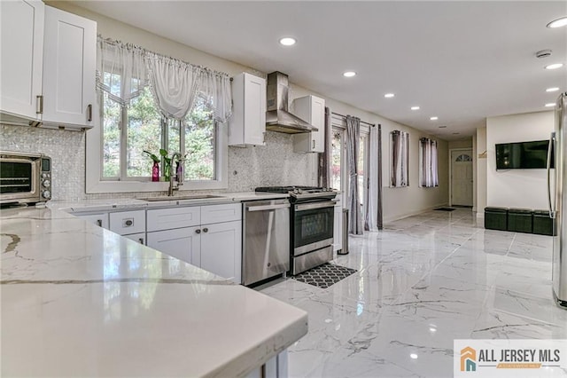 kitchen with stove, a sink, marble finish floor, wall chimney range hood, and dishwasher