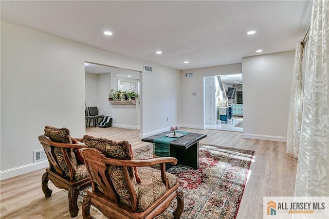 sitting room featuring visible vents, baseboards, light wood-style flooring, and recessed lighting