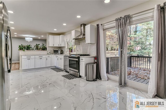 kitchen with recessed lighting, stainless steel appliances, marble finish floor, wall chimney range hood, and light countertops