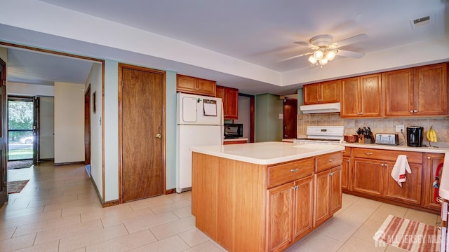 9 Toby Ter, Monroe, NJ 08831 - kitchen featuring freestanding refrigerator, under cabinet range hood, stove, light countertops, and backsplash