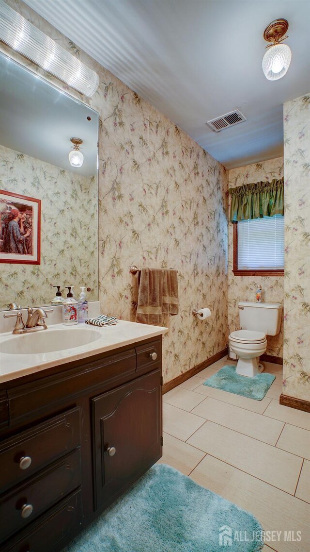 9 Toby Ter, Monroe, NJ 08831 - half bath with vanity, toilet, tile patterned floors, and baseboards