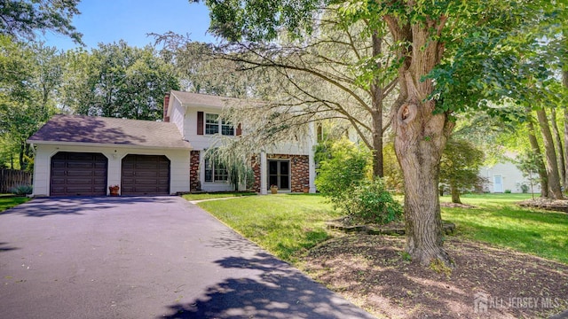 9 Toby Ter, Monroe, NJ 08831 - view of front facade with asphalt driveway, an attached garage, a front lawn, and roof with shingles