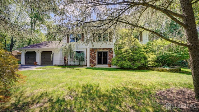 9 Toby Ter, Monroe, NJ 08831 - view of front of house with a garage, a front lawn, brick siding, and driveway