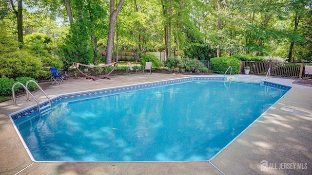 9 Toby Ter, Monroe, NJ 08831 - view of swimming pool featuring a fenced backyard, a patio area, and view of scattered trees