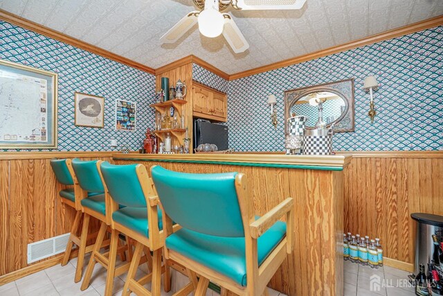 interior space featuring visible vents, an ornate ceiling, wallpapered walls, and ornamental molding