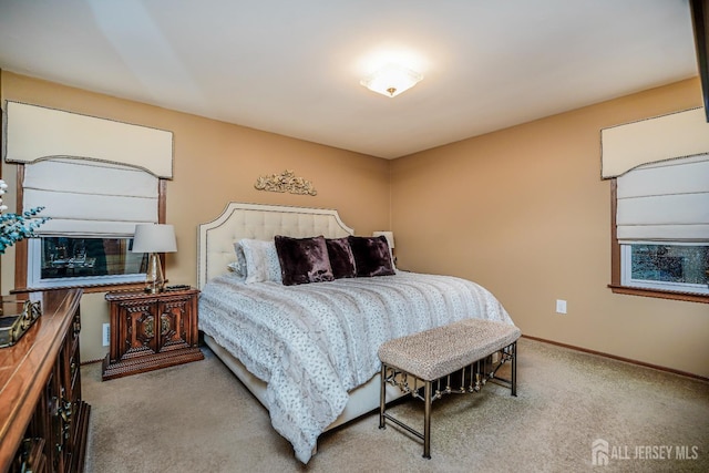 carpeted bedroom featuring baseboards