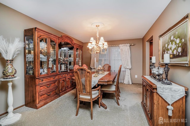 dining area with an inviting chandelier, baseboards, and light carpet