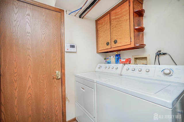 washroom featuring cabinet space and washing machine and dryer