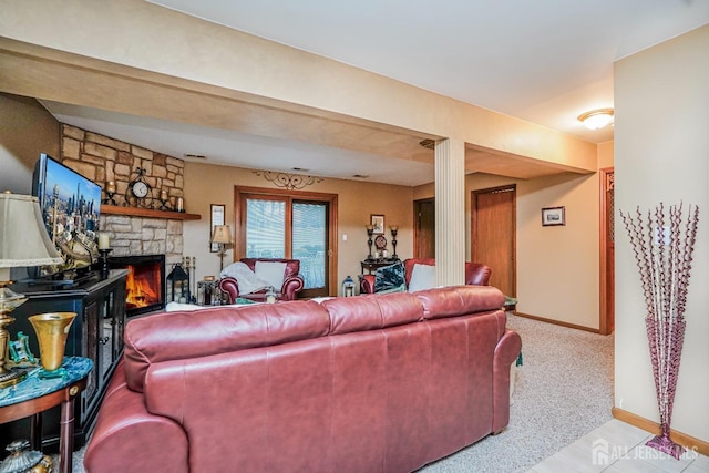 carpeted living room featuring a fireplace and baseboards