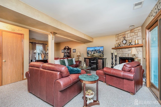 living room featuring visible vents and a fireplace