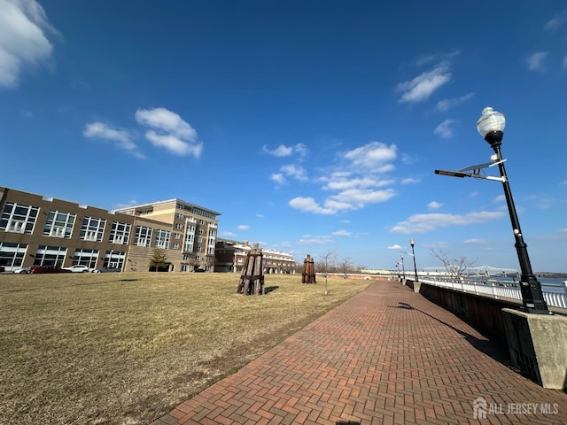 view of property's community featuring a water view and a lawn