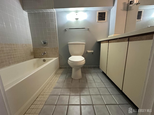 bathroom featuring toilet, tile patterned flooring, visible vents, and baseboards