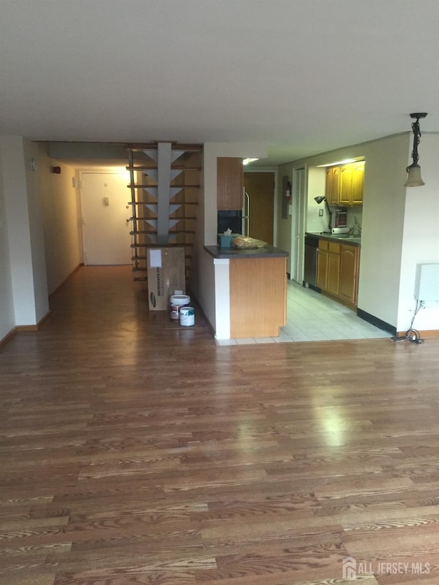 kitchen with hanging light fixtures and wood-type flooring