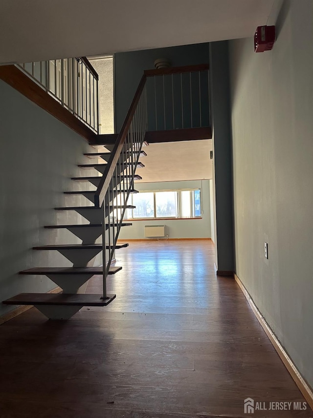 stairs featuring baseboards and wood finished floors