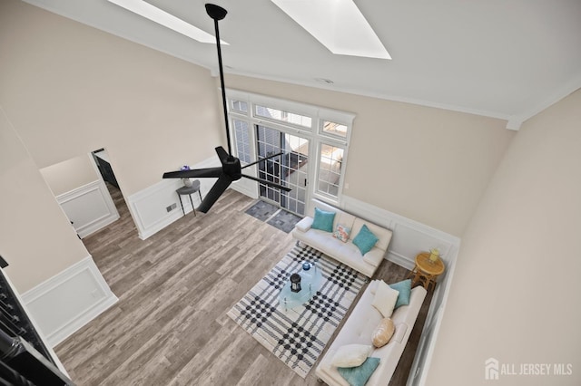 77 Winthrop Rd Unit C, Monroe Township, NJ 08331 - living area with a skylight, wood finished floors, a wainscoted wall, ornamental molding, and a decorative wall