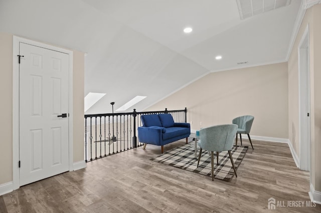 77 Winthrop Rd Unit C, Monroe Township, NJ 08331 - sitting room with baseboards, visible vents, wood finished floors, and vaulted ceiling with skylight