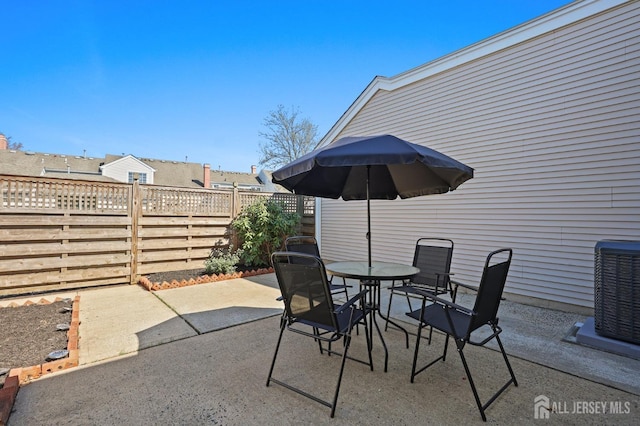 77 Winthrop Rd Unit C, Monroe Township, NJ 08331 - view of patio / terrace featuring a fenced backyard, outdoor dining space, and cooling unit