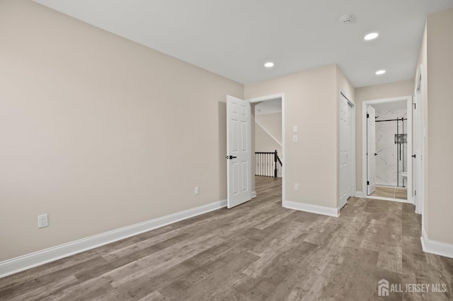 77 Winthrop Rd Unit C, Monroe Township, NJ 08331 - unfurnished bedroom featuring baseboards, recessed lighting, connected bathroom, and wood finished floors