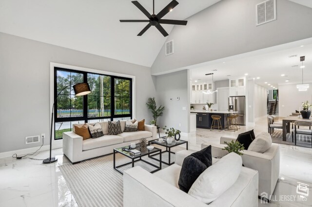 living room featuring high vaulted ceiling and ceiling fan