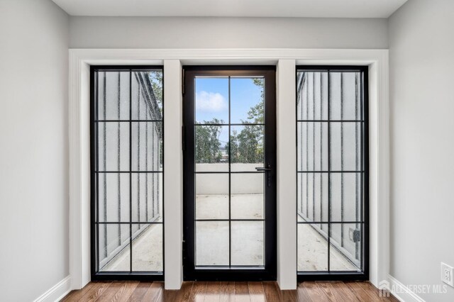 doorway to outside with wood-type flooring