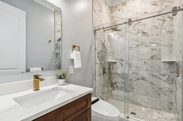 bathroom featuring a shower with door, vanity, and toilet