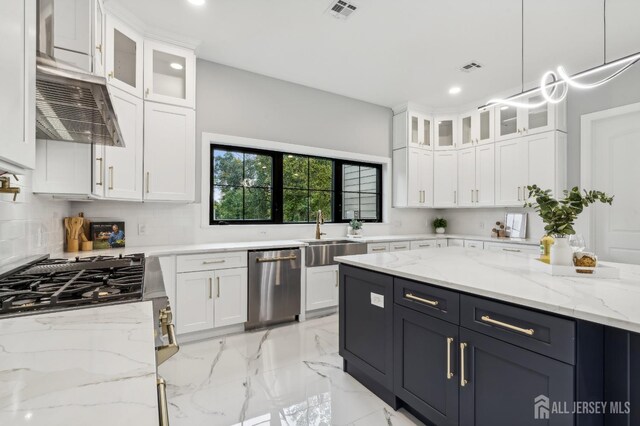 kitchen featuring sink, stainless steel dishwasher, light stone countertops, decorative light fixtures, and white cabinetry