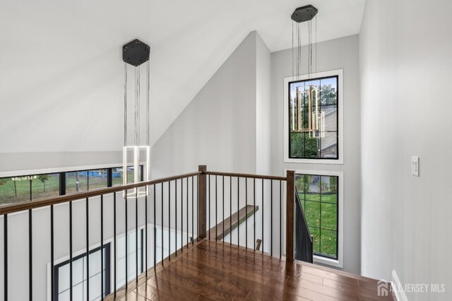 hall featuring hardwood / wood-style flooring and a notable chandelier