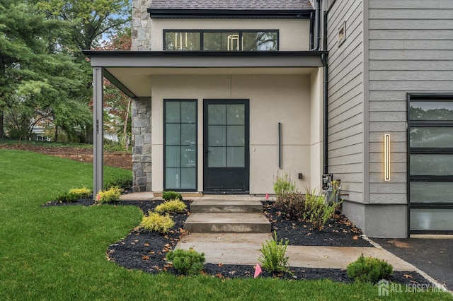 entrance to property with a lawn