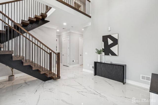 entryway featuring ornamental molding