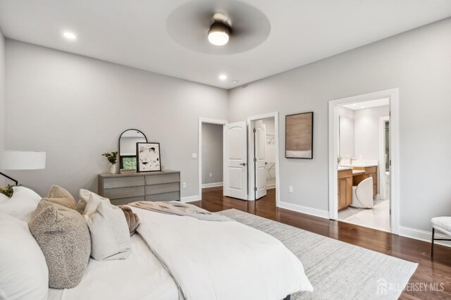 bedroom with connected bathroom, ceiling fan, and wood-type flooring