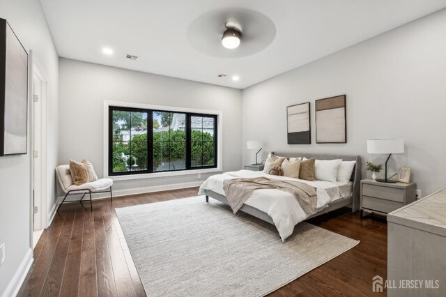 bedroom with ceiling fan and dark hardwood / wood-style flooring