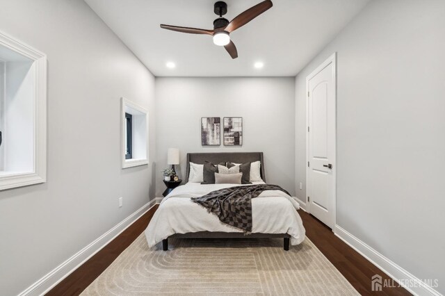 bedroom with ceiling fan and dark wood-type flooring