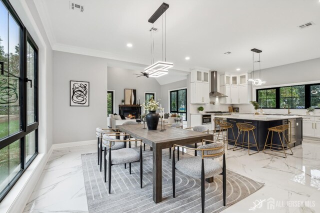 dining area with ceiling fan and sink