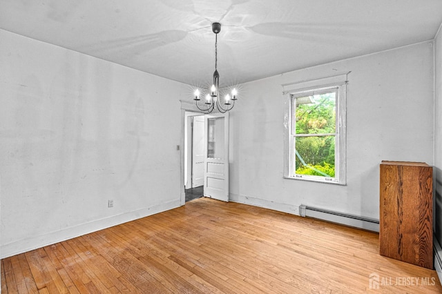 110 N 5th Ave N, Highland Park, NJ 08904 - unfurnished room with baseboard heating, a chandelier, and light wood-type flooring