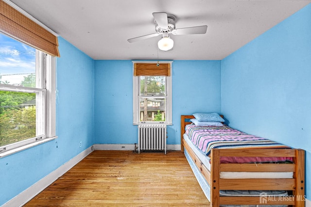 110 N 5th Ave N, Highland Park, NJ 08904 - bedroom with radiator, wood finished floors, baseboards, and a ceiling fan
