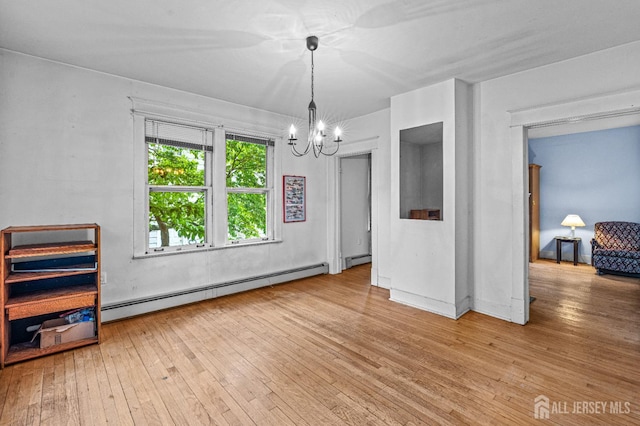 110 N 5th Ave N, Highland Park, NJ 08904 - spare room featuring baseboard heating, a chandelier, and hardwood / wood-style flooring