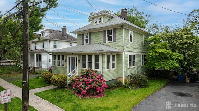 110 N 5th Ave N, Highland Park, NJ 08904 - american foursquare style home with a chimney, a front lawn, and entry steps
