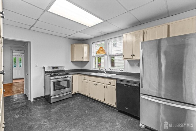 110 N 5th Ave N, Highland Park, NJ 08904 - kitchen with appliances with stainless steel finishes, a sink, dark countertops, a drop ceiling, and cream cabinets