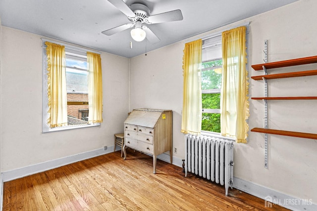 110 N 5th Ave N, Highland Park, NJ 08904 - bedroom with radiator, wood finished floors, baseboards, and ceiling fan