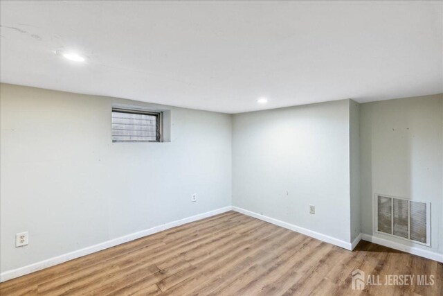 spare room with light wood-type flooring